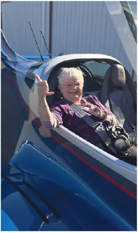 Pilot seated in an open-canopy airplane