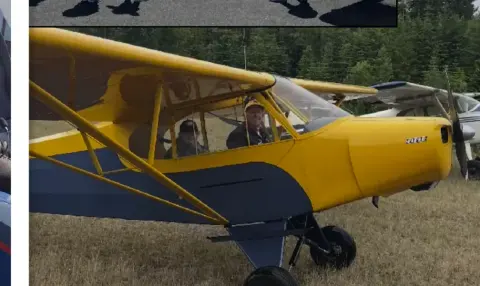Yellow Cub-type airplane on a grass field