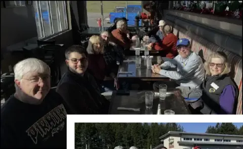 Fly-out group having lunch at a long restaurant table