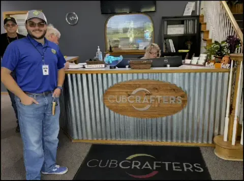 Aidan standing in front of a CubCrafters counter