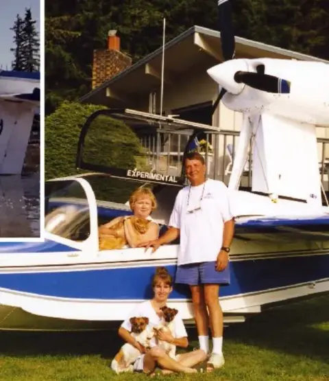 A family posing with their amphibian on the lawn