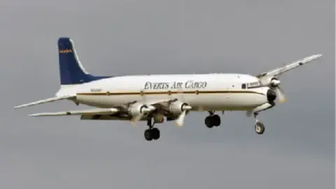 Four-engine DC-6 cargo airplane in flight
