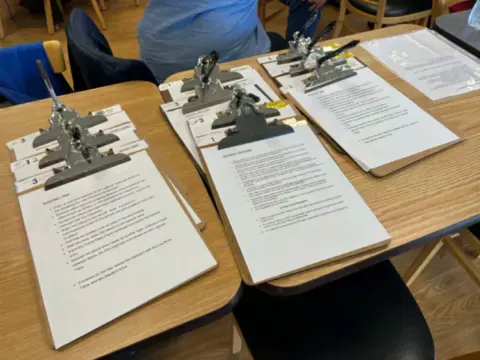 Clipboards with Young Eagles paperwork laid out on a table