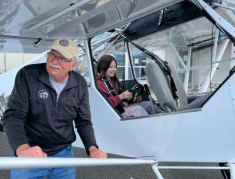 Ernie standing beside his Super Cub with a Young Eagle in the back seat