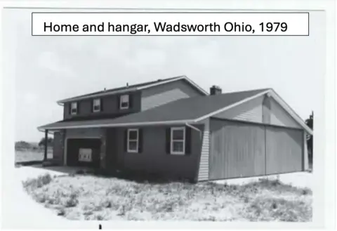 Black and white photo of a house and hangar (caption: Home and hangar, Wadsworth Ohio, 1979)