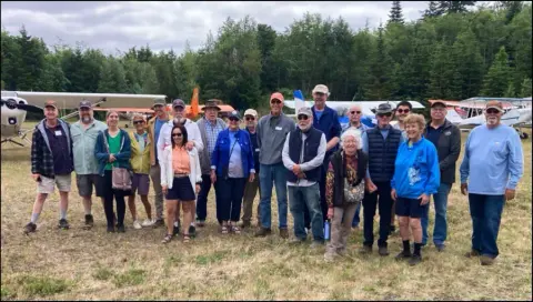 Fly-out group posing on the grass at Olympic Field