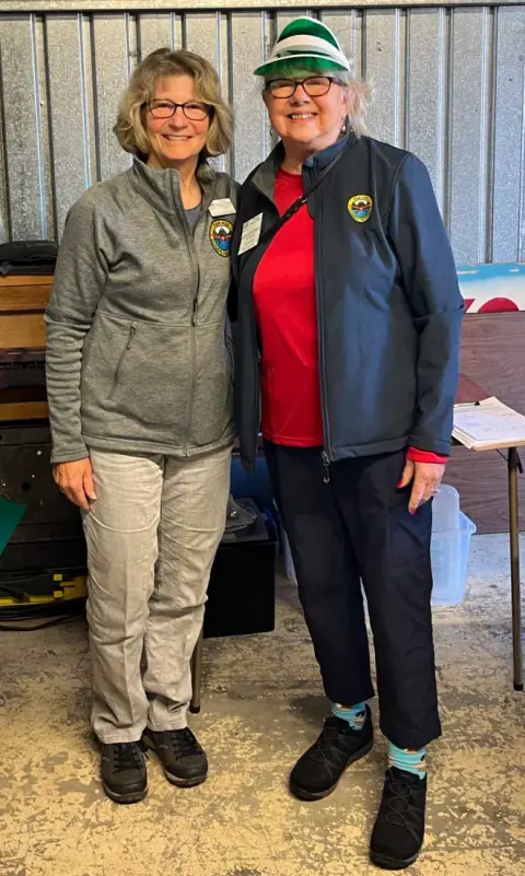 Lisa Ballantyne and Tracy Halsted standing together in the hangar
