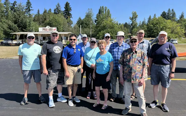 Fly-out group posing in front of the Spruce Goose Café at Jefferson County International