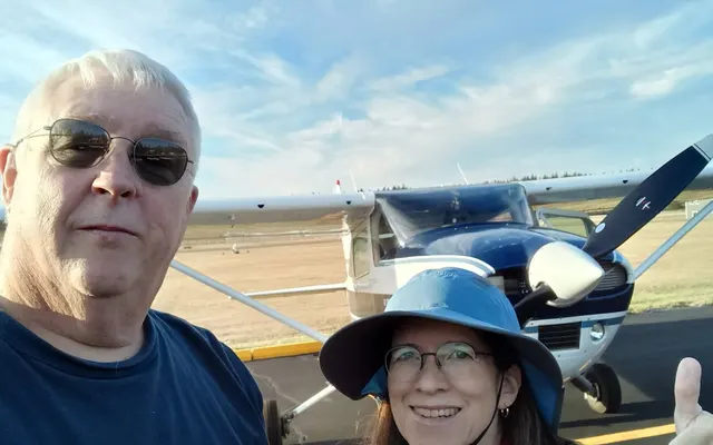 Kevin Tracy and DPE Cecilia Aragon smiling in a selfie in front of an airplane